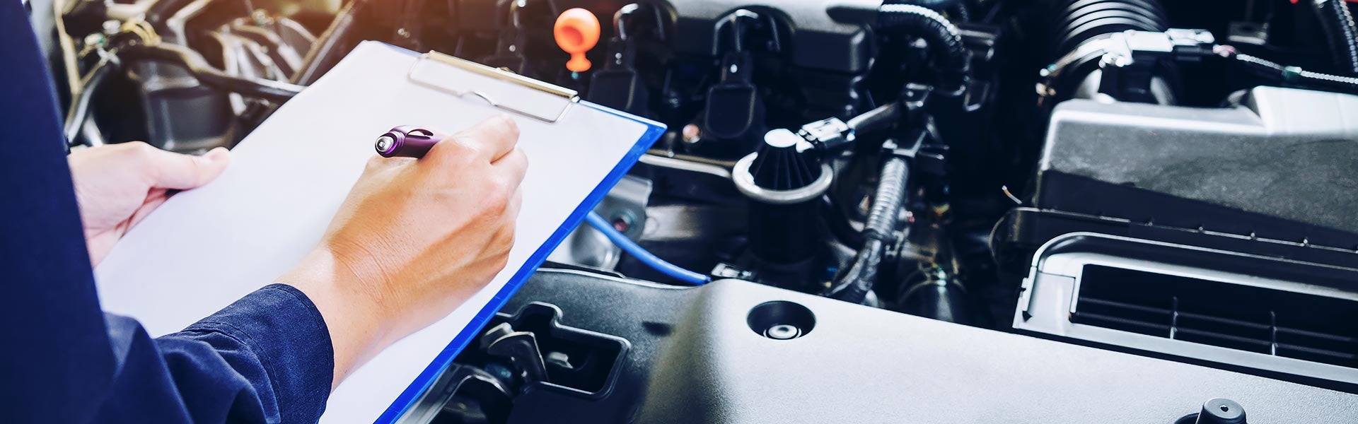 Photo of a mechanic inspecting a vehicle
